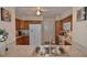 Clean kitchen with stainless steel sink, oak cabinets, white appliances, and laminate countertops at 1203 Hudson Rd, Venice, FL 34293