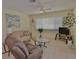 Cozy living room with neutral tones, ceiling fan and tile floors at 1203 Hudson Rd, Venice, FL 34293