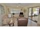 Bright living room featuring a sliding glass door to the lanai at 1203 Hudson Rd, Venice, FL 34293