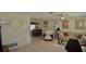 Bright and airy living room and dining area featuring tile floors, neutral paint, and ceiling fans at 1203 Hudson Rd, Venice, FL 34293
