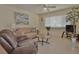 Inviting living room featuring tile flooring, neutral walls, ceiling fan, and comfortable seating at 1203 Hudson Rd, Venice, FL 34293