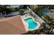 Aerial view of a backyard pool area, complete with lush landscaping and privacy fencing at 1203 Hudson Rd, Venice, FL 34293