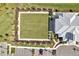 Aerial view showcasing a community lawn, parking, and clubhouse at 12538 Somatic Ct, Venice, FL 34293