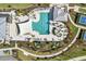 Aerial view of community pool and amenity center featuring swimming, tennis, and lounge areas at 12538 Somatic Ct, Venice, FL 34293