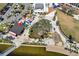 Aerial view of town center park, lake, splash pad and a beautiful canopy of trees at 12538 Somatic Ct, Venice, FL 34293