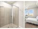 Bathroom featuring glass shower and view into bedroom at 12538 Somatic Ct, Venice, FL 34293