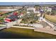 Aerial view of a waterfront community park with splash pad, green space, and shops at 12538 Somatic Ct, Venice, FL 34293