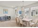 Bright dining room with tile floors, modern pendant lighting, and a stylish blue and grey sideboard cabinet at 12538 Somatic Ct, Venice, FL 34293