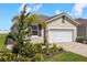 Charming single-story home featuring a well-manicured lawn and a two-car garage with brick paved drive at 12538 Somatic Ct, Venice, FL 34293