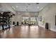 Spacious fitness studio with hardwood floors, weights, mirrors and large windows at 12538 Somatic Ct, Venice, FL 34293
