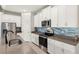 Kitchen with stainless steel appliances, gray countertops, and modern backsplash at 12538 Somatic Ct, Venice, FL 34293