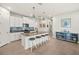 Bright kitchen featuring an island with bar seating, pendant lighting, and modern appliances at 12538 Somatic Ct, Venice, FL 34293