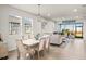 Open-concept living space with tile floors, neutral furnishings, and seamless access to the screened lanai at 12538 Somatic Ct, Venice, FL 34293