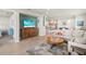 Open living space with tile flooring, and a stylish media center, seamlessly connected to the kitchen and dining area at 12538 Somatic Ct, Venice, FL 34293