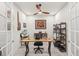 Bright office space featuring a unique wood desk, shelving, and stylish decor and lighting at 12538 Somatic Ct, Venice, FL 34293