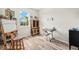 Sunlit studio space with an easel, storage cabinet, and craft table, perfect for creative endeavors at 12538 Somatic Ct, Venice, FL 34293