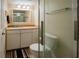 Bright bathroom featuring a glass shower, a toilet, a mirror, and great lighting at 1255 Tarpon Center Dr # 604, Venice, FL 34285