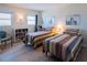 Cozy bedroom with two twin beds, wood flooring, and nice furniture and decor at 1255 Tarpon Center Dr # 604, Venice, FL 34285