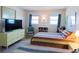 Inviting bedroom with two beds, a dresser with TV, wood flooring, and great natural light at 1255 Tarpon Center Dr # 604, Venice, FL 34285