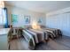 Comfortable bedroom featuring two twin beds, wood flooring, and ample storage space at 1255 Tarpon Center Dr # 604, Venice, FL 34285