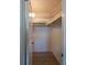 Walk-in closet with storage shelves, hanging rod, and wood flooring at 1255 Tarpon Center Dr # 604, Venice, FL 34285