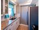 This is a lovely kitchen featuring granite countertops, stainless steel refrigerator, and a sink with window view at 1255 Tarpon Center Dr # 604, Venice, FL 34285