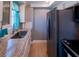 Galley kitchen featuring stainless steel appliances, granite countertops and white cabinets at 1255 Tarpon Center Dr # 604, Venice, FL 34285