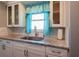 Updated kitchen with granite countertops, white cabinets, and stainless steel faucet at 1255 Tarpon Center Dr # 604, Venice, FL 34285