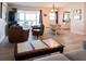 Comfortable living room with a sofa, armchair, TV, dining table, and balcony access at 1255 Tarpon Center Dr # 604, Venice, FL 34285