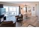 Spacious living room with ample seating, dining area, and balcony overlooking the bay at 1255 Tarpon Center Dr # 604, Venice, FL 34285