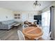 Living room featuring a sofa, TV, dining table and chairs and balcony access at 1255 Tarpon Center Dr # 604, Venice, FL 34285