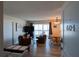Bright living room with two leather chairs, dining table and chairs, and access to a balcony at 1255 Tarpon Center Dr # 604, Venice, FL 34285