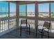 Cozy sun room with chairs and a beautiful view of the surrounding area at 1255 Tarpon Center Dr # 604, Venice, FL 34285