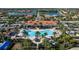 Aerial view of a community pool, clubhouse and tennis courts at 13829 Alafaya St, Venice, FL 34293