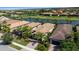 Aerial view of a neighborhood featuring tile roofs and community lake at 13829 Alafaya St, Venice, FL 34293