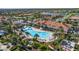 Aerial view of a large community pool, clubhouse and palm trees at 13829 Alafaya St, Venice, FL 34293