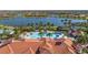 Aerial view of the community pool featuring a waterslide and lake views at 13829 Alafaya St, Venice, FL 34293