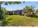 Landscaped backyard with screened-in patio and well-maintained lawn at 13829 Alafaya St, Venice, FL 34293