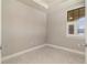 An empty bedroom with neutral paint, tiled floors, and a window with shutters at 13829 Alafaya St, Venice, FL 34293