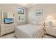 Cozy bedroom with white furniture, natural light, and comfortable bedding at 13829 Alafaya St, Venice, FL 34293