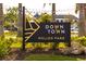 Well-maintained entrance sign to Downtown Wellen Park with manicured landscaping and mature palm trees at 13829 Alafaya St, Venice, FL 34293