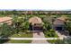 Beautiful single-story home with a brick drive, two-car garage, and mature tropical landscaping at 13829 Alafaya St, Venice, FL 34293
