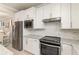 Well-equipped kitchen with stainless steel appliances, white cabinets, and granite countertops at 13829 Alafaya St, Venice, FL 34293