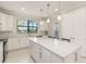 Modern kitchen with stainless steel appliances, quartz countertops, and white cabinetry at 13829 Alafaya St, Venice, FL 34293