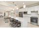 Bright, open kitchen boasts white cabinets, stainless steel appliances, and a spacious center island at 13829 Alafaya St, Venice, FL 34293