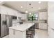 Modern kitchen with stainless steel appliances, quartz countertops, and white cabinetry at 13829 Alafaya St, Venice, FL 34293