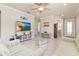 Bright living room with tile floors, neutral paint, and a view into other rooms at 13829 Alafaya St, Venice, FL 34293