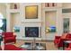 Comfortable resident lounge with red chairs, fireplace and flat screen televisions at 13829 Alafaya St, Venice, FL 34293