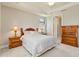 A naturally lit bedroom with a tray ceiling and wood furniture at 13829 Alafaya St, Venice, FL 34293