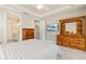 Spacious bedroom with a tv, tray ceilings, view to Primary bathroom and outdoor views at 13829 Alafaya St, Venice, FL 34293